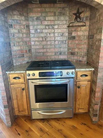 a stove top oven sitting inside of a kitchen