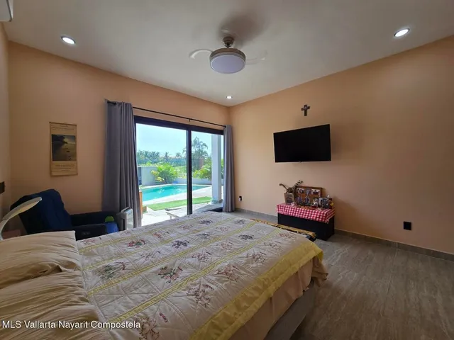 a bedroom with a bed and a flat screen tv