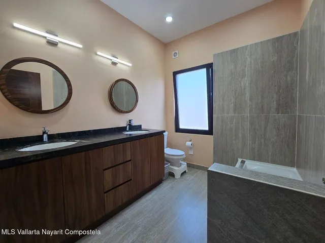 a bathroom with a double vanity sink and a mirror