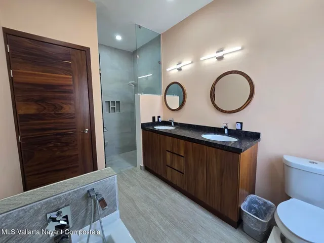 a bathroom with a toilet a sink and a mirror