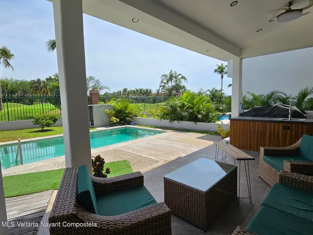 swimming pool view with a garden and outdoor seating