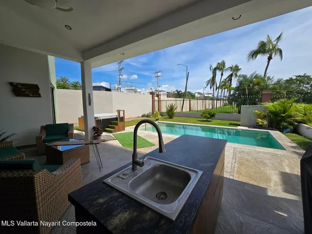 a view of a chairs and table in patio