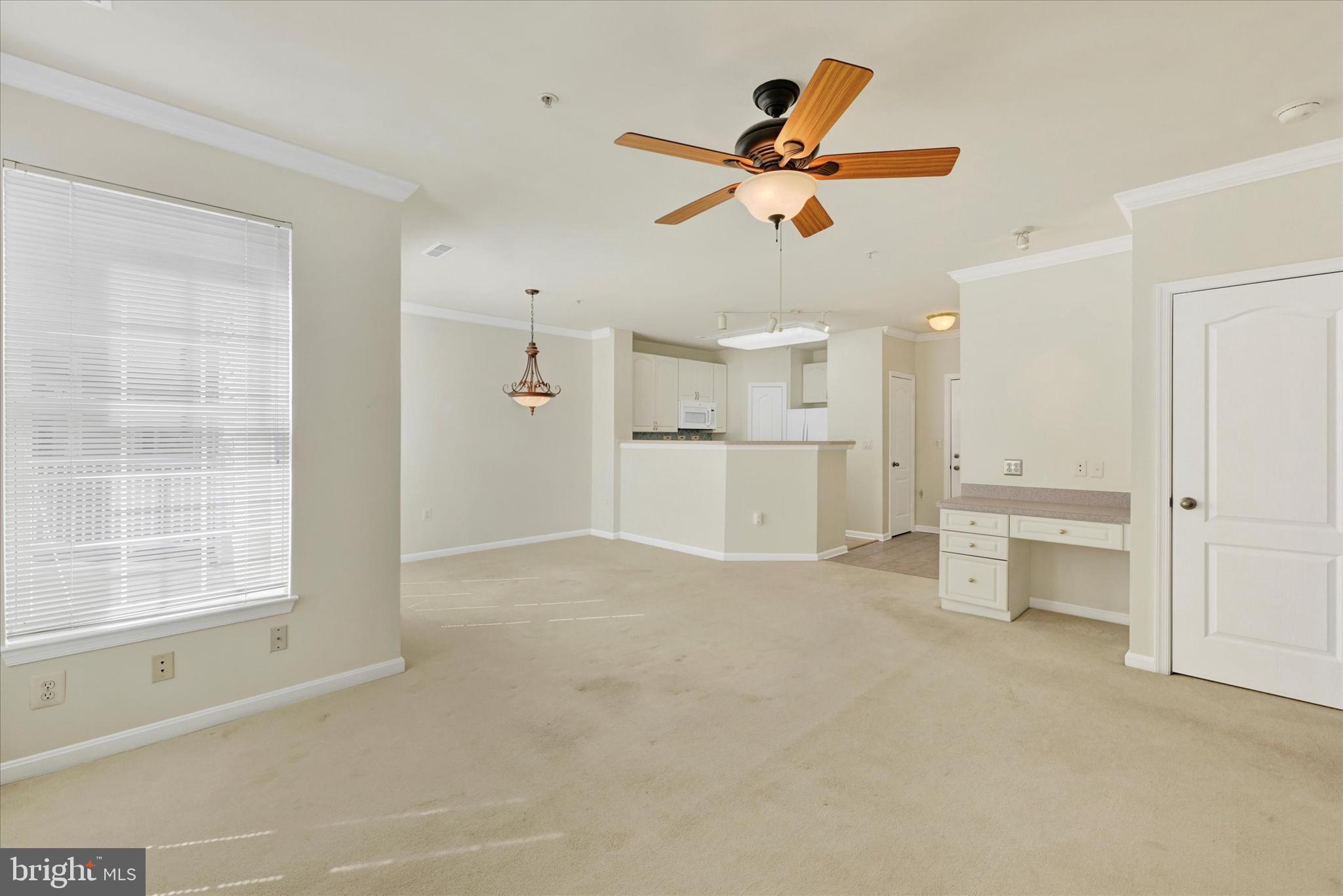 400 Symphony Circle, Unit 414 Hunt Valley, MD 21030 - Photo 17 of 29 an empty room with a kitchen and windows