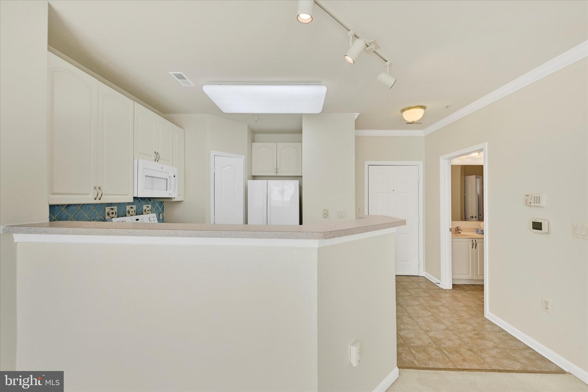 400 Symphony Circle, Unit 414 Hunt Valley, MD 21030 - Photo 4 of 29 a view of kitchen with stainless steel appliances furniture refrigerator and window