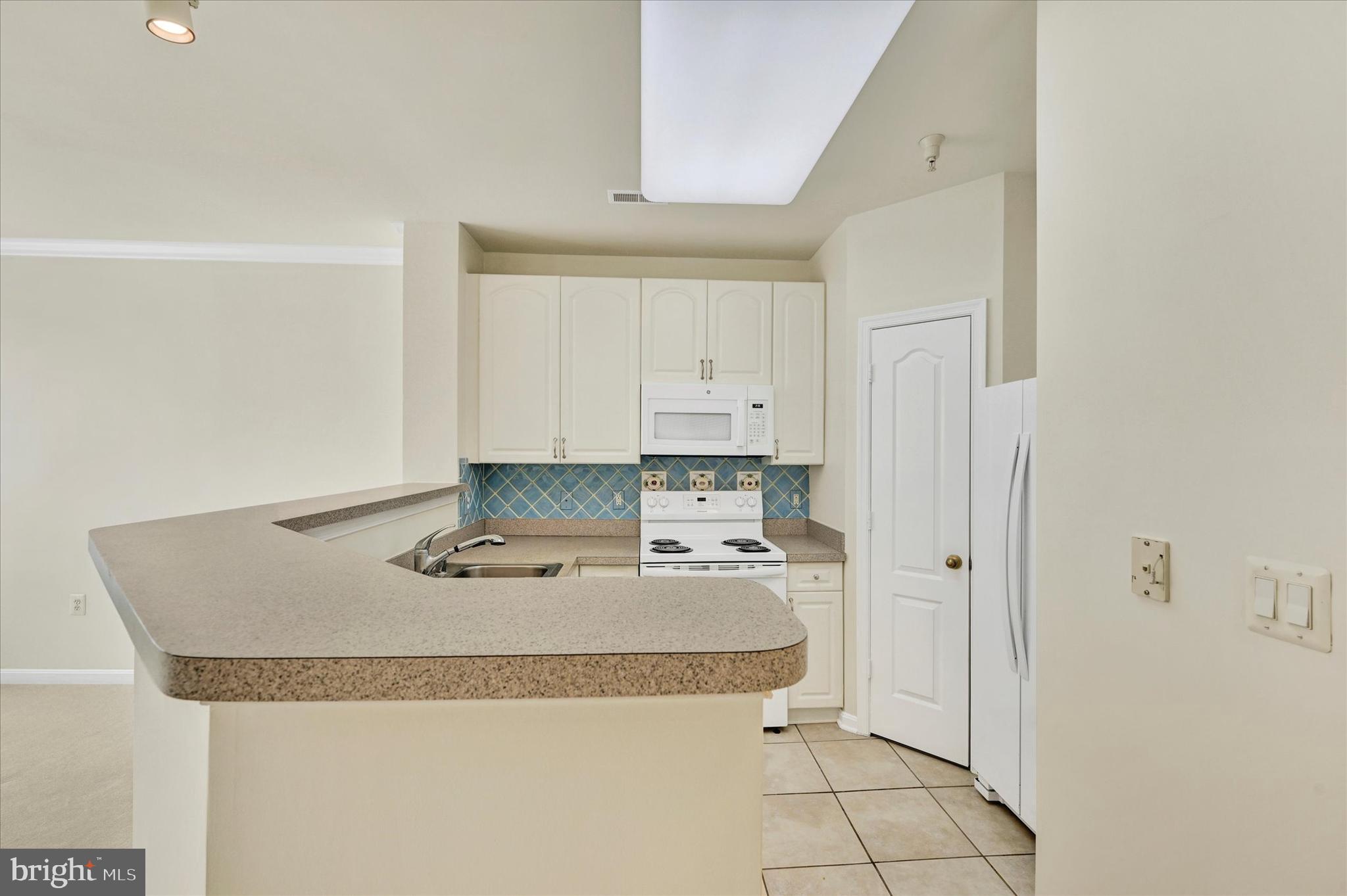 400 Symphony Circle, Unit 414 Hunt Valley, MD 21030 - Photo 5 of 29 a bathroom with a granite countertop sink and a mirror