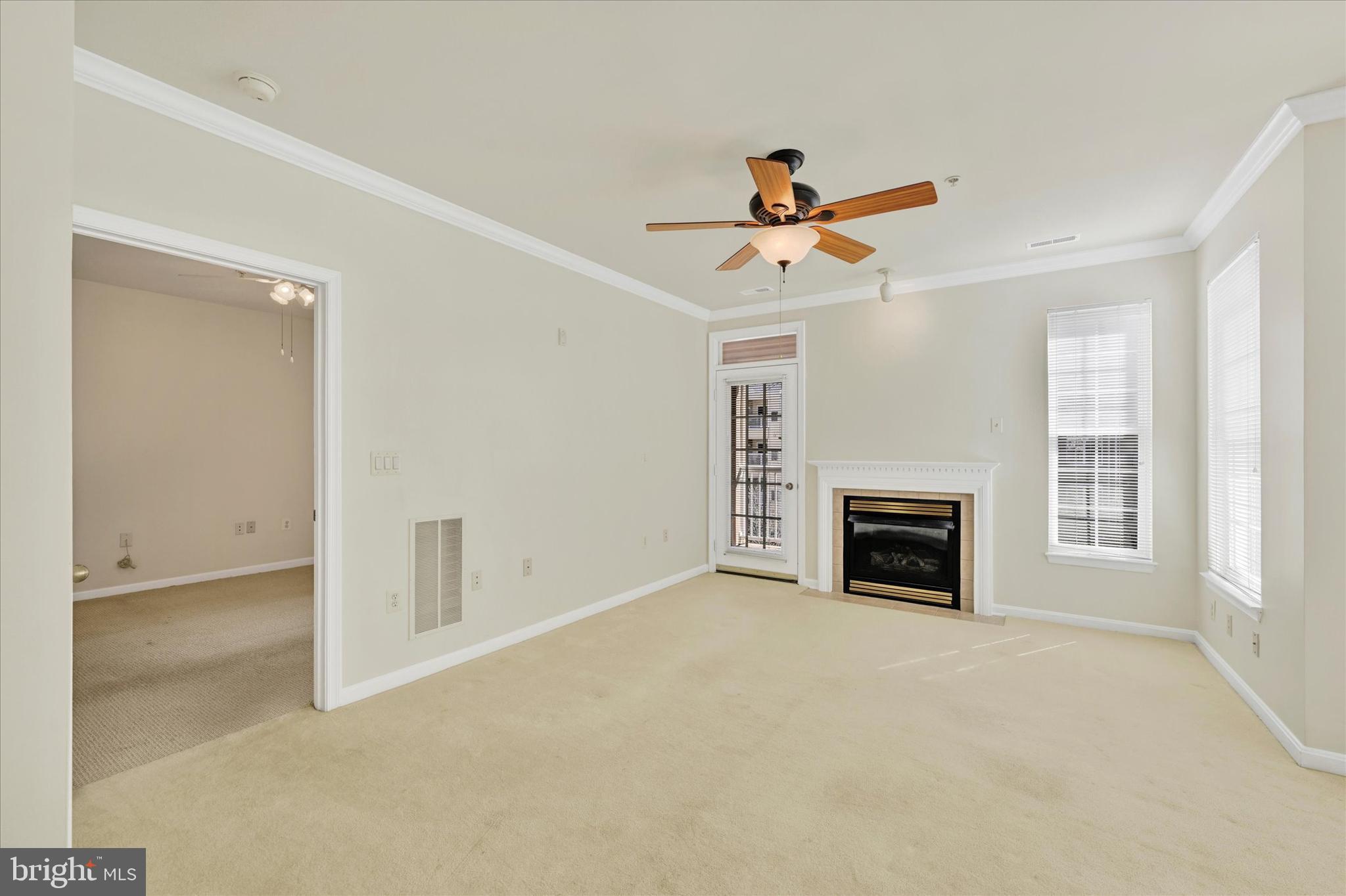 400 Symphony Circle, Unit 414 Hunt Valley, MD 21030 - Photo 10 of 29 an empty room with windows and fireplace