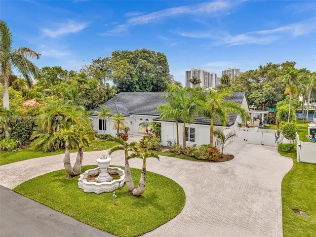 a front view of a house with a garden and yard