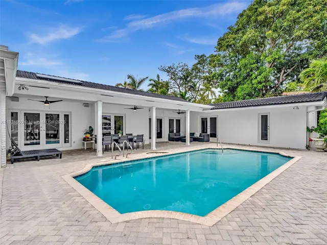a view of a kitchen with a stove and a floor to ceiling window