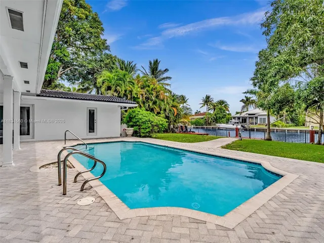 a view of a swimming pool with a yard