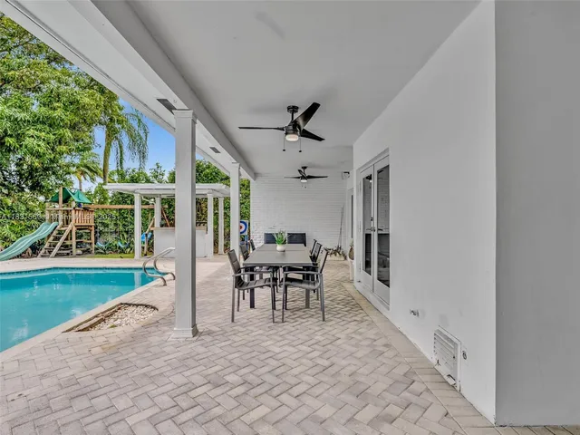 a view of a house with a backyard and a small park