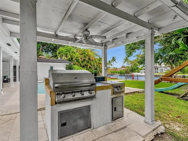 a living room with fireplace furniture and a potted plant