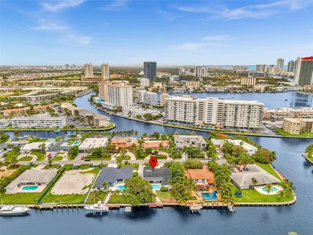 a large kitchen with cabinets chairs and refrigerator