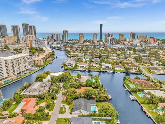 a kitchen with stainless steel appliances kitchen island granite countertop a sink and cabinets