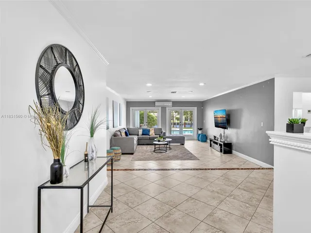 a view of a dining room with furniture and a chandelier