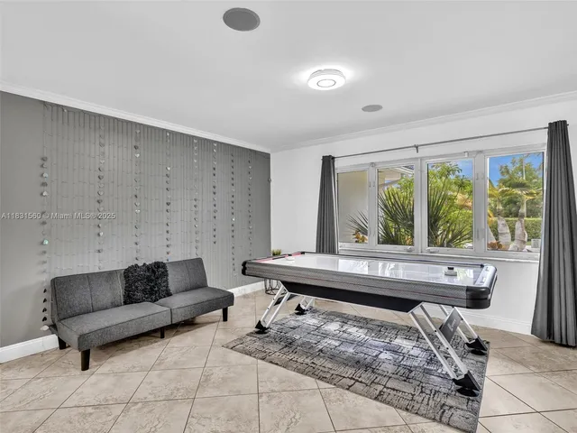 a bedroom with two beds and a large window