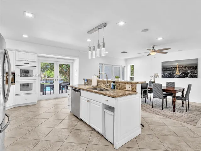 a bathroom with a sink a toilet a mirror and shower