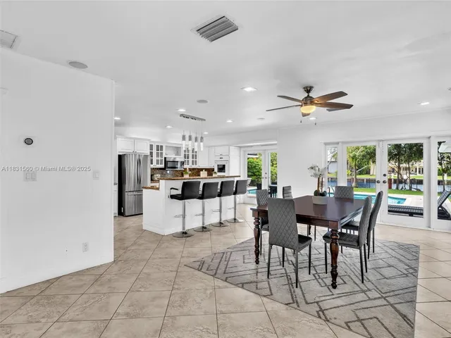 a view of a livingroom with wooden floor and a flat screen tv