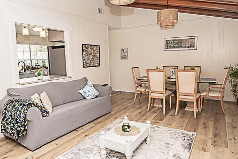 a living room with furniture wooden floor and a table