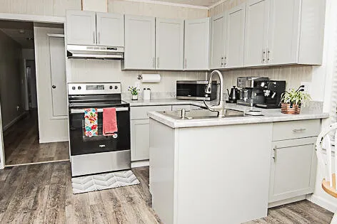 a kitchen with stainless steel appliances granite countertop a refrigerator sink and stove