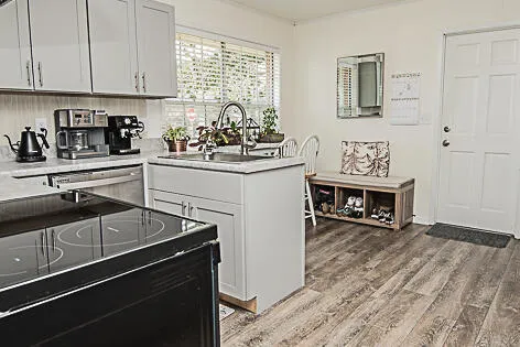 a kitchen with stainless steel appliances a sink stove and cabinets