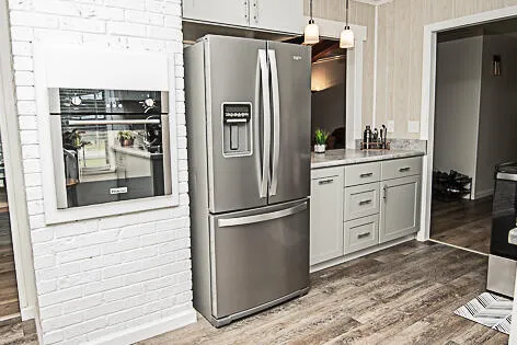 a kitchen with stainless steel appliances a refrigerator sink and cabinets