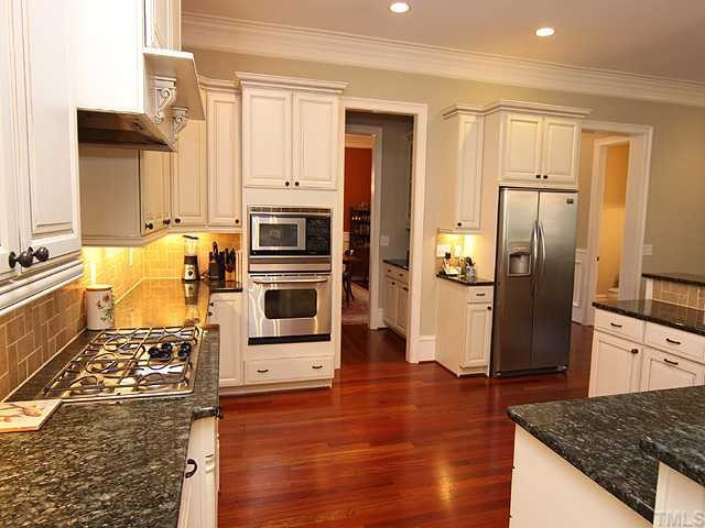 Expansive kitchen with granite, french country custom cabinetry, stainless, a 36" gas cooktop is totally open to main living and entertaining area. Kitchen