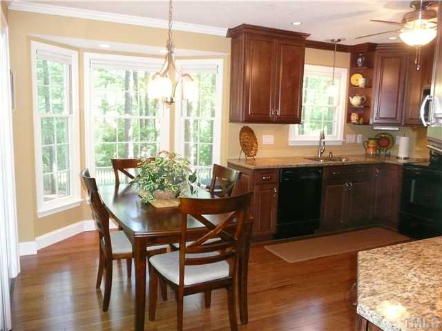 5464 Ingate Way Raleigh, NC 27613 - Photo 6 of 22 Breakfast area includes brushed nickel fixture, bay window and modern sliding door to the deck.