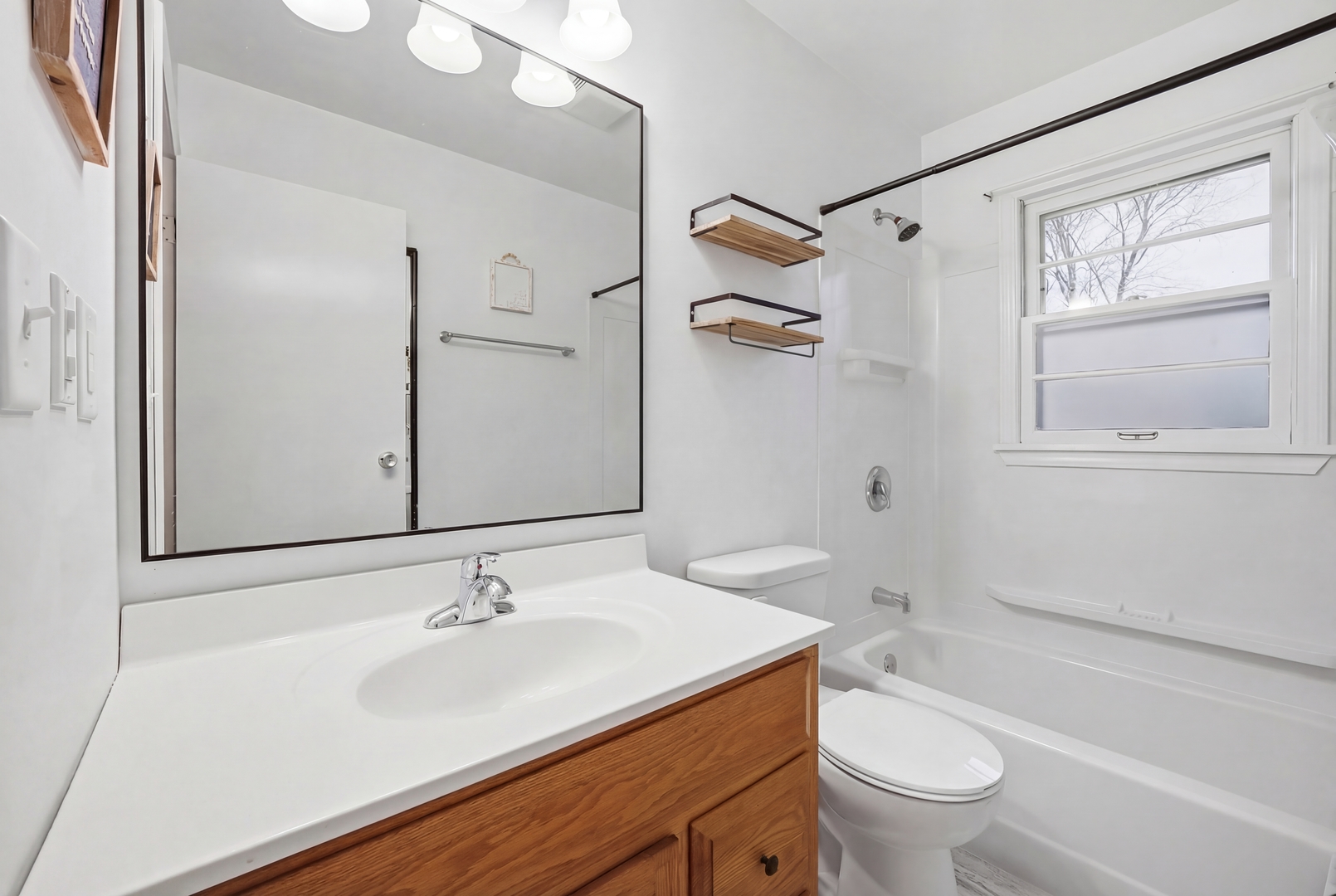 200 Ramona Avenue Rochelle, IL 61068 - Photo 17 of 21 a bathroom with a sink toilet vanity and shower
