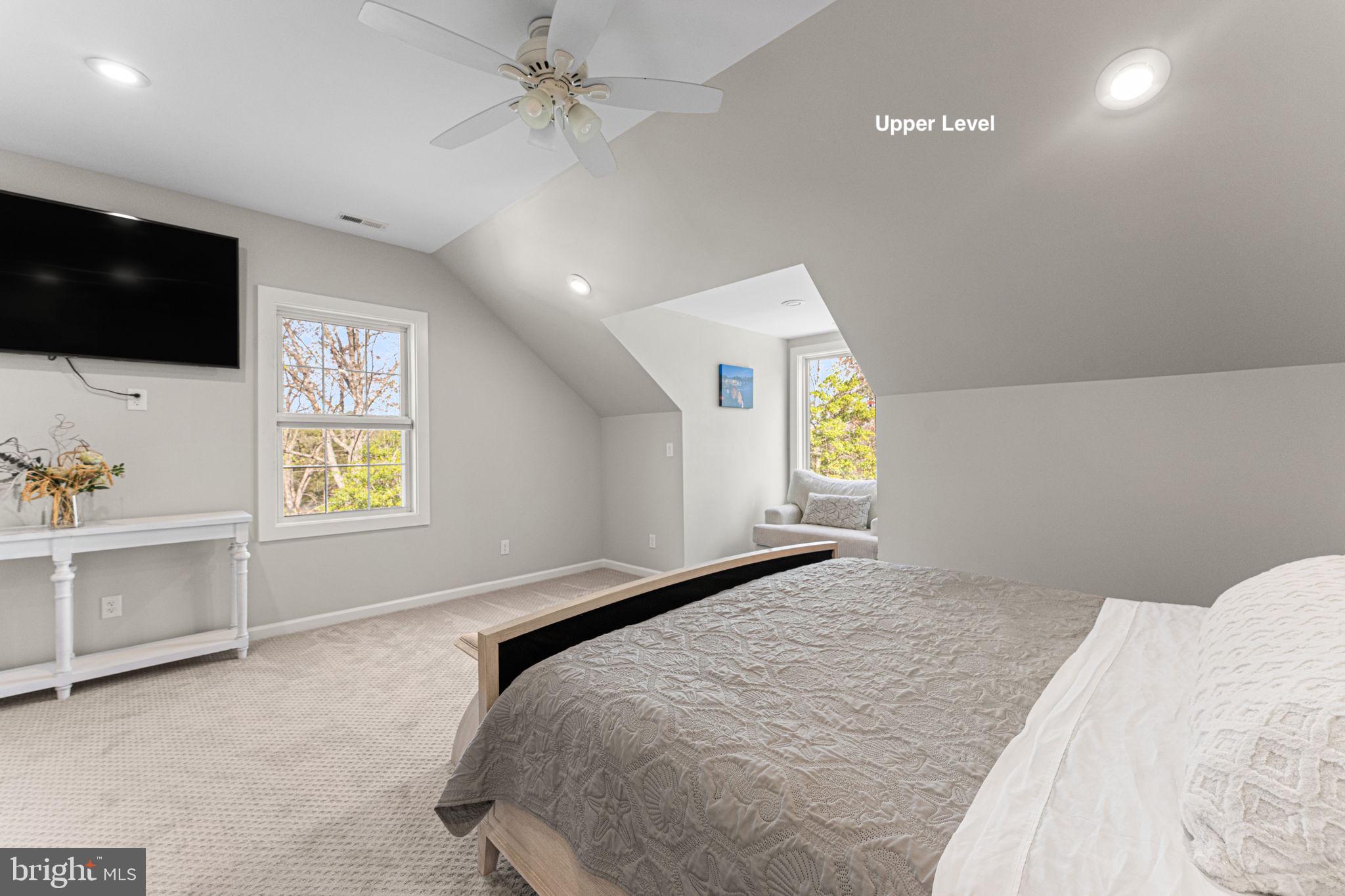 249 Spring Hill Road Lancaster, VA 22503 - Photo 38 of 65 a bedroom with a bed and a flat screen tv