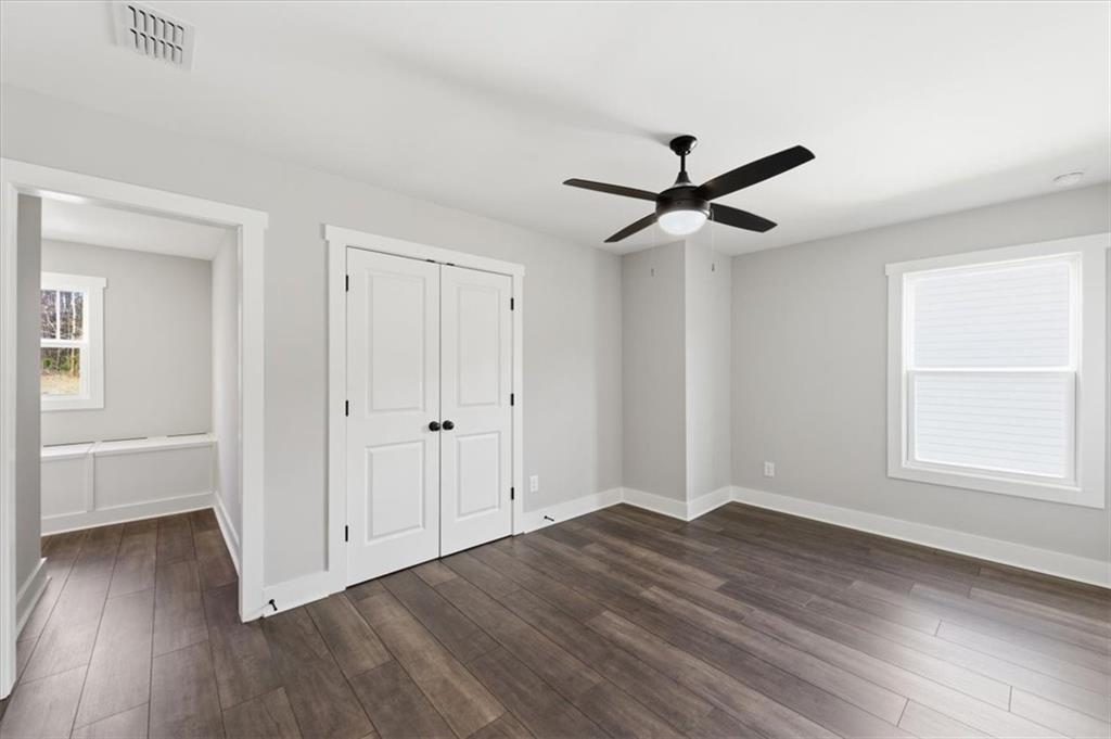 139 Old Alabama Road Southeast Emerson, GA 30137 - Photo 33 of 50 an empty room with wooden floor chandelier fan and windows