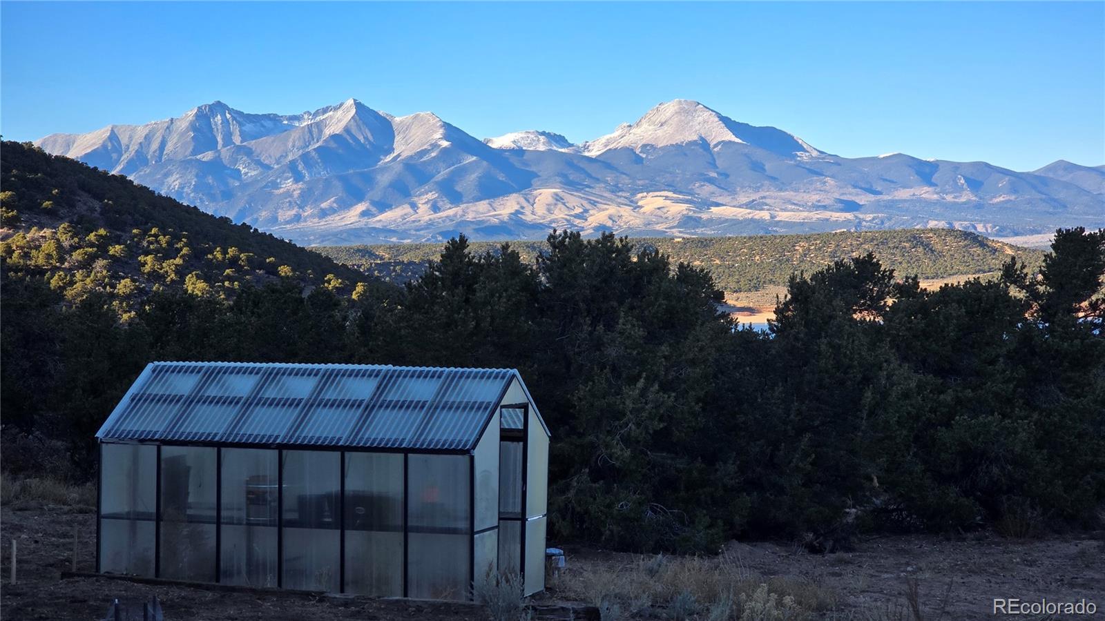 411 Gruenberg Road Fort Garland, CO 81133 - Photo 39 of 41 a view of a house with a yard and mountain view