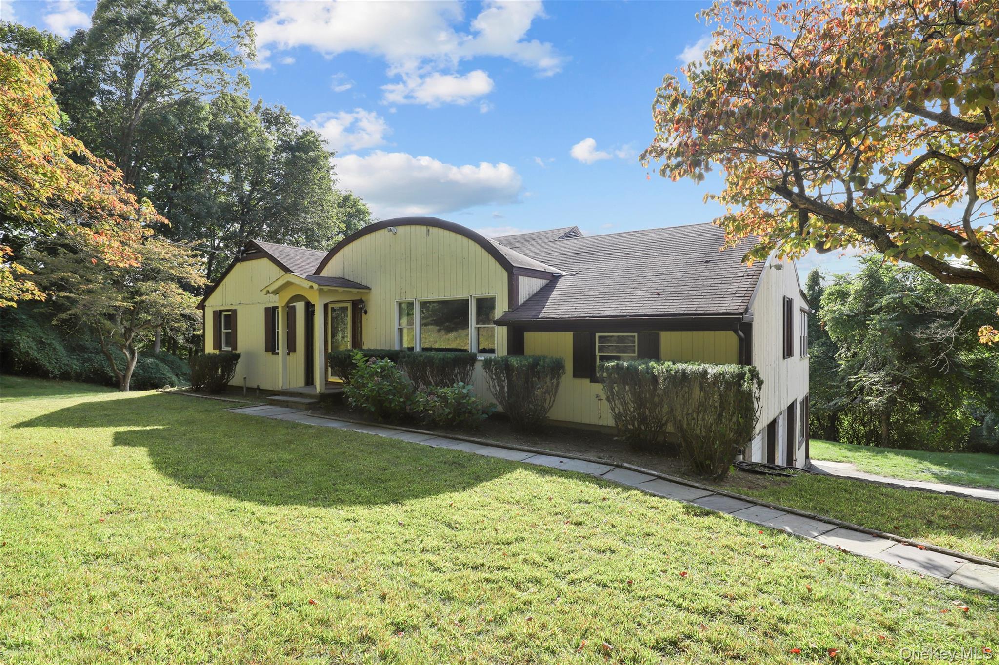a front view of a house with garden