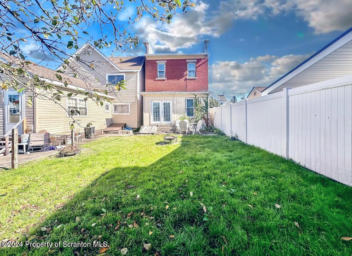 218 Hand Street, Unit 2 Jessup, PA 18434 - Photo 2 of 15 a view of a house with a big yard potted plants and large tree