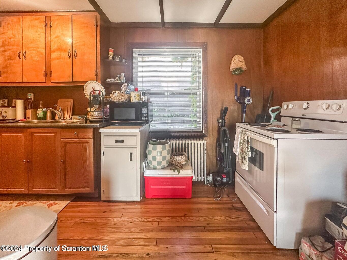 218 Hand Street, Unit 2 Jessup, PA 18434 - Photo 10 of 15 a view of a kitchen with fridge and wooden floor
