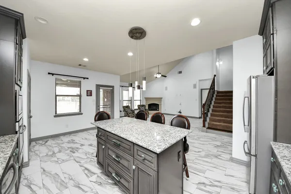 a living room with granite countertop furniture and a fireplace