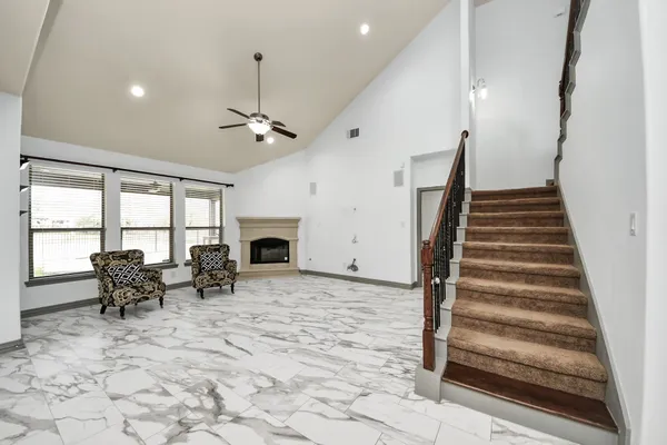 a view of a livingroom with furniture and staircase