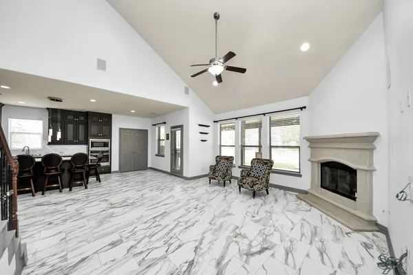 a view of a livingroom with furniture fireplace and window