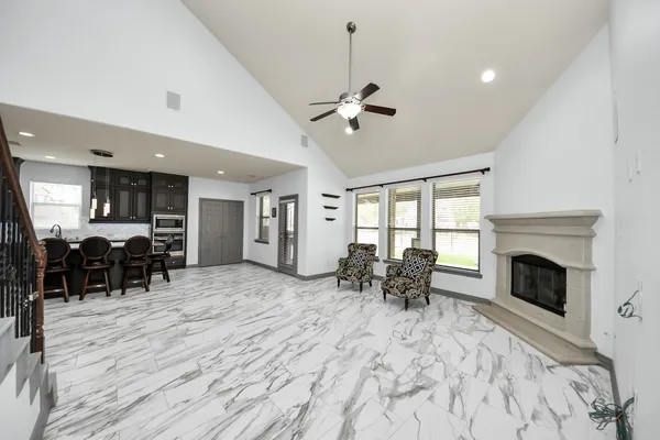 a view of a livingroom with furniture and a kitchen