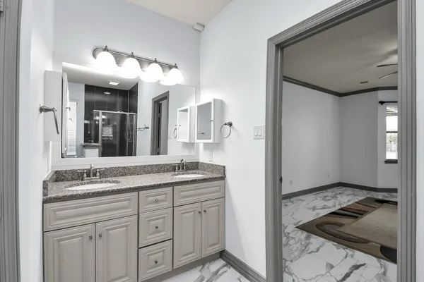 a bathroom with a granite countertop sink mirror and vanity