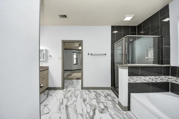 a bathroom with a tub and a sink