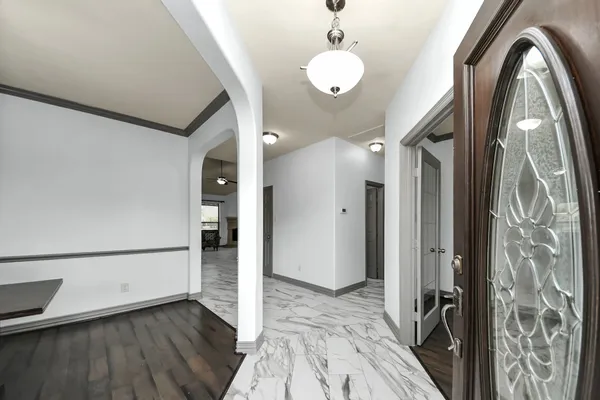 a view of a livingroom with wooden floor and stairs