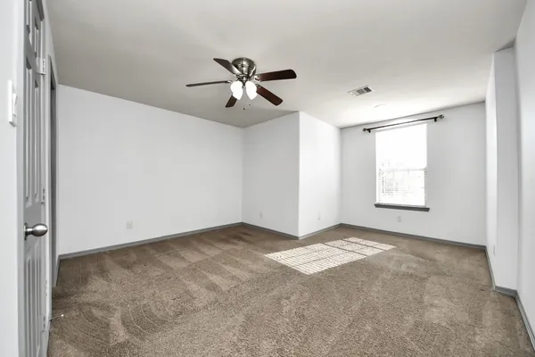 a view of an empty room with a window