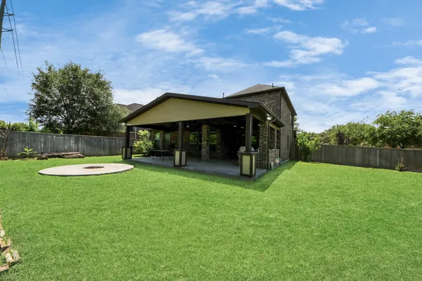 a view of a house with backyard and sitting area