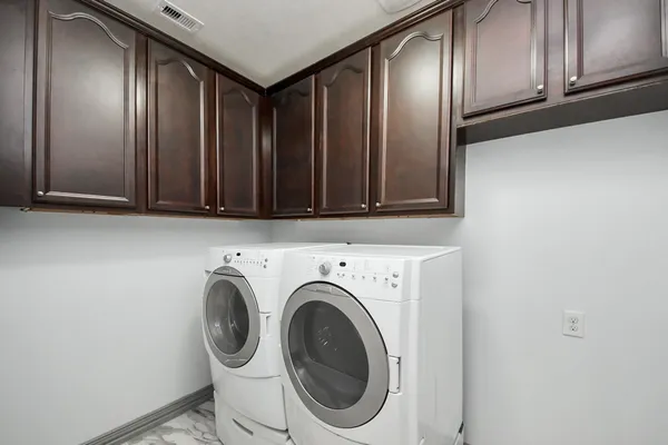a view of a storage and utility room with washer and dryer