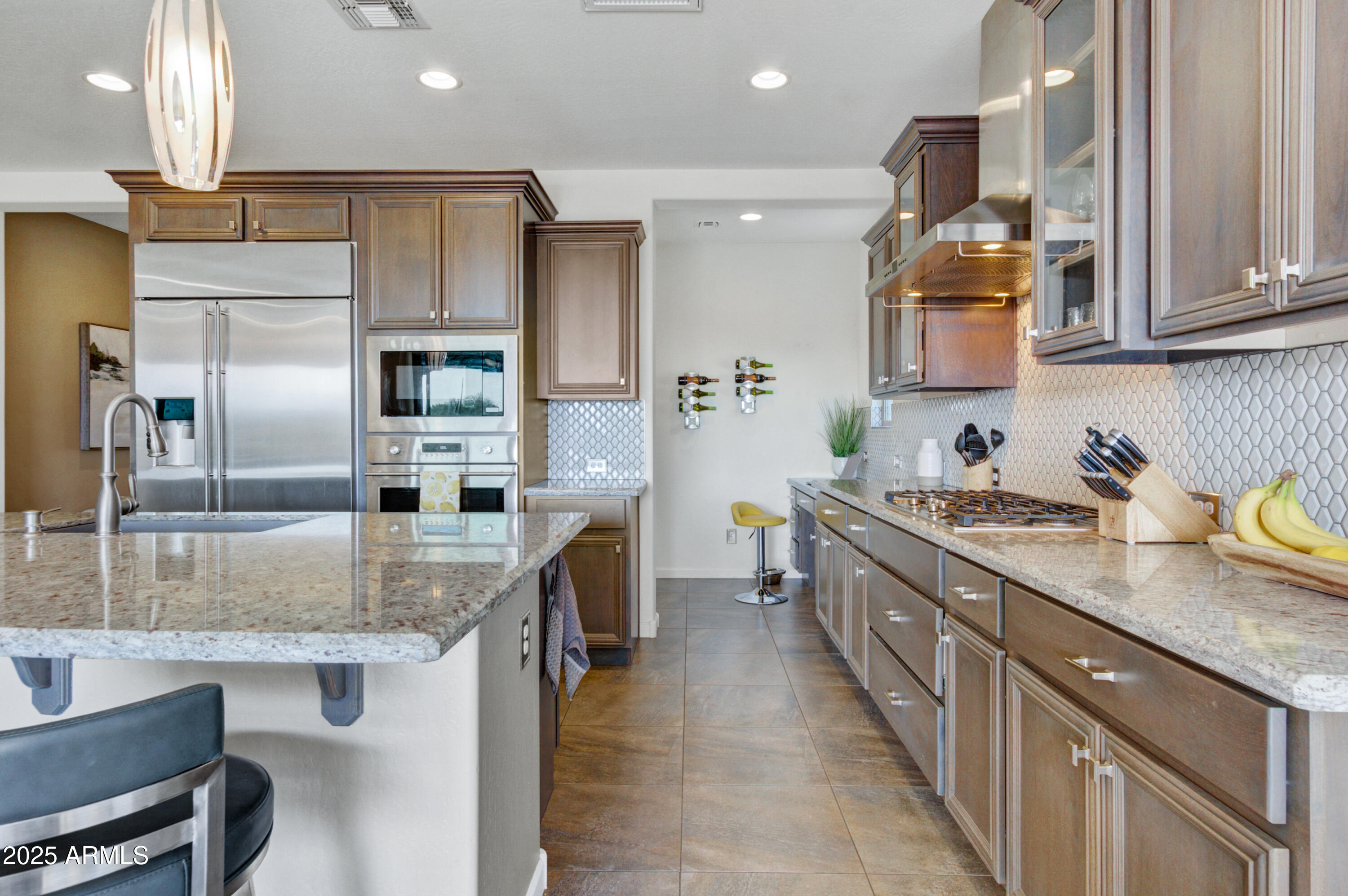 17919 East Slide Rock Drive Rio Verde, AZ 85263 - Photo 12 of 48 a kitchen with stainless steel appliances granite countertop a sink stove and refrigerator