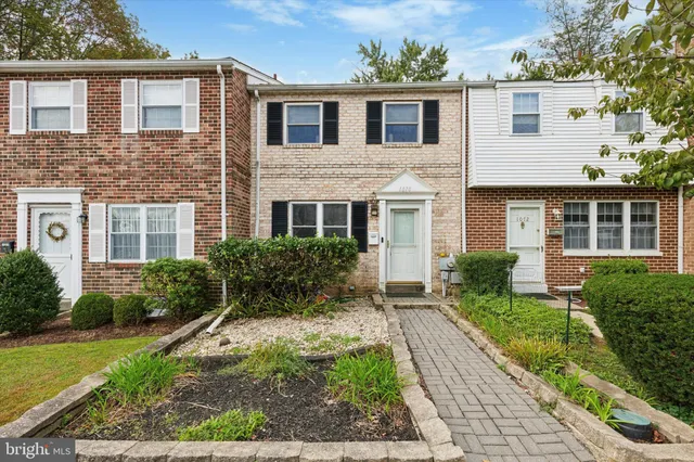 a front view of a house with garden and porch