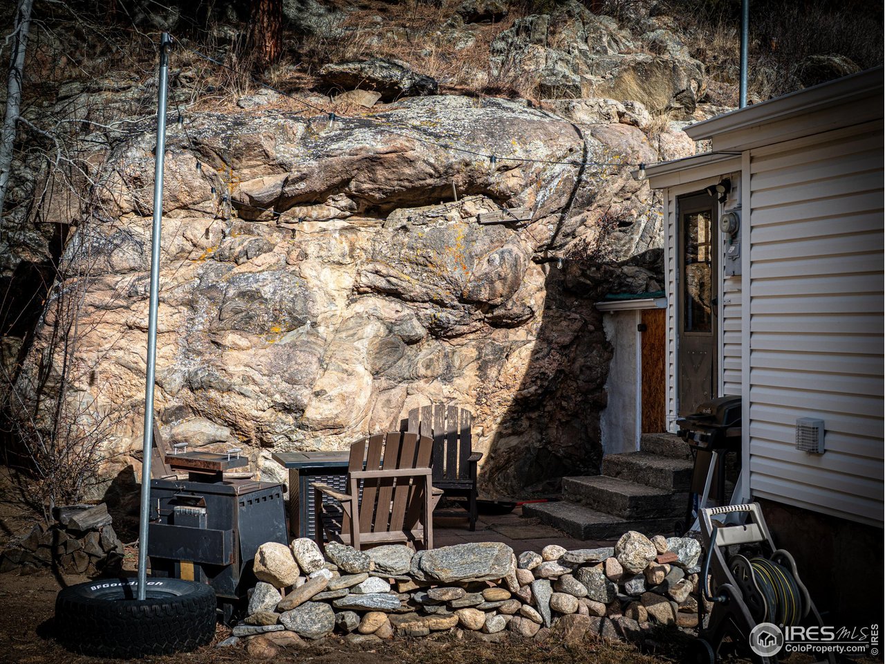 2127 Us Highway Drake, CO 80515 - Photo 14 of 34 a backyard of a house with lots of green space and outdoor seating