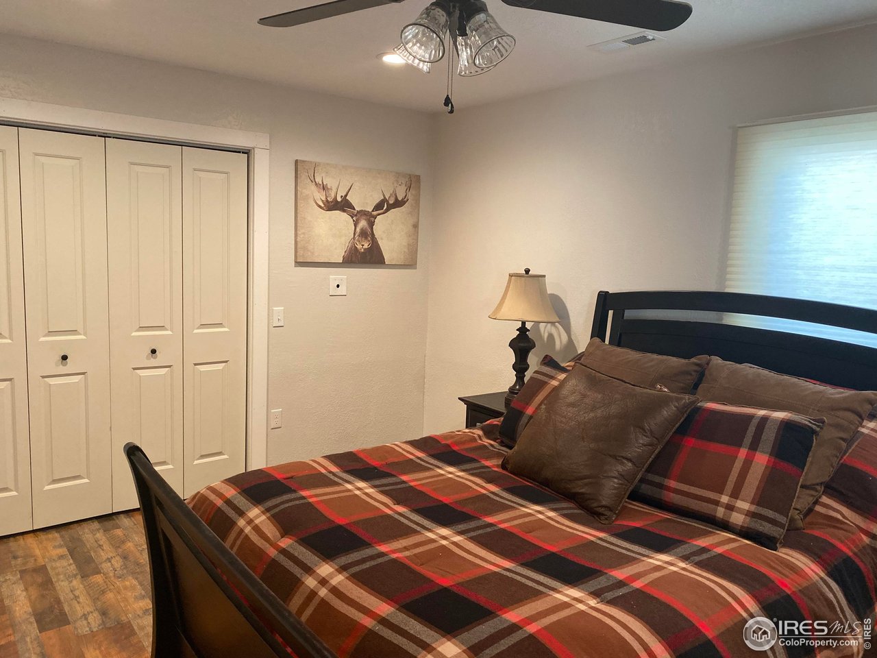 2127 Us Highway Drake, CO 80515 - Photo 10 of 34 a bedroom with a bed and a chandelier