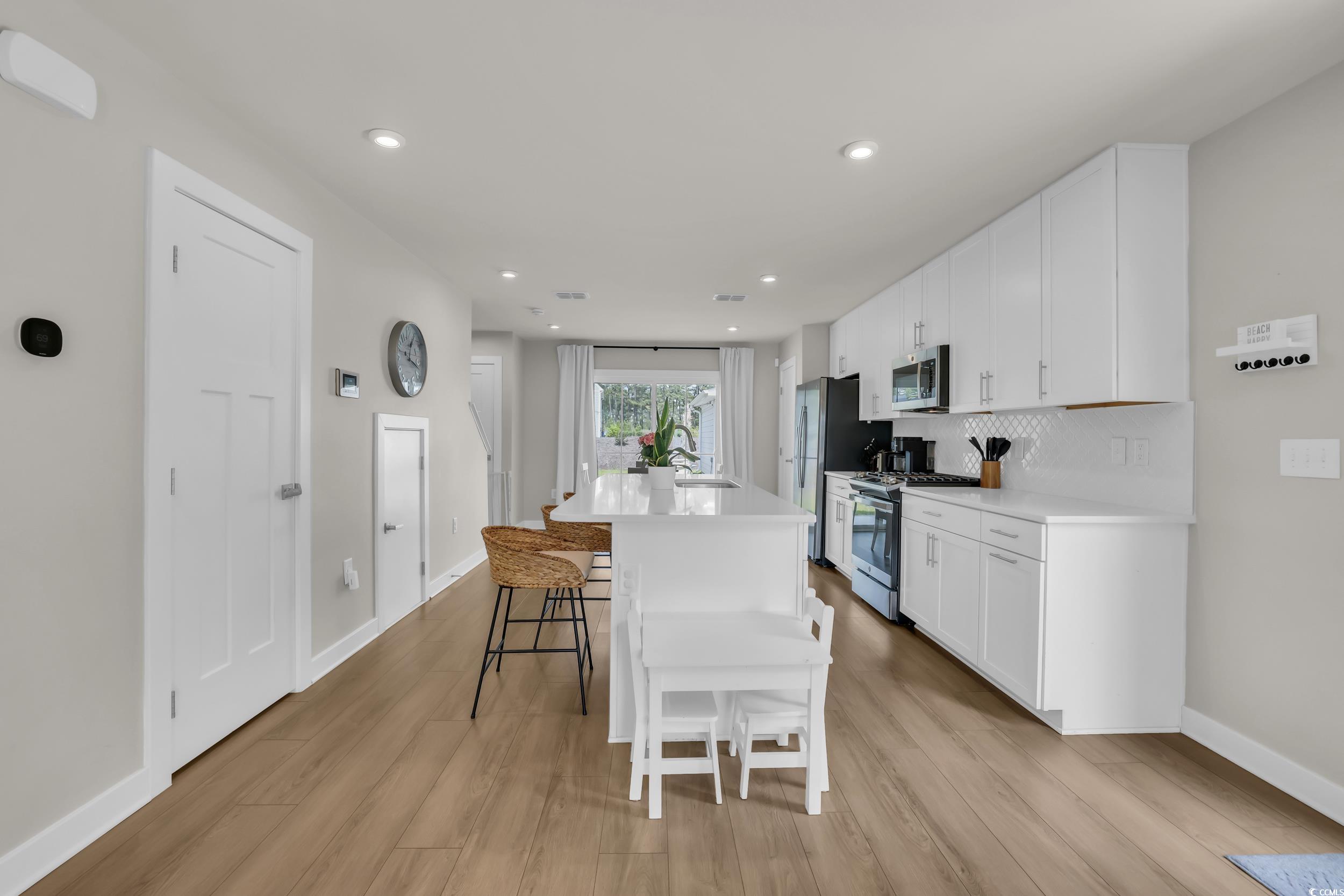 9012 Mabel Court Longs, SC 29568 - Photo 6 of 26 Kitchen with a breakfast bar, light wood-type floo