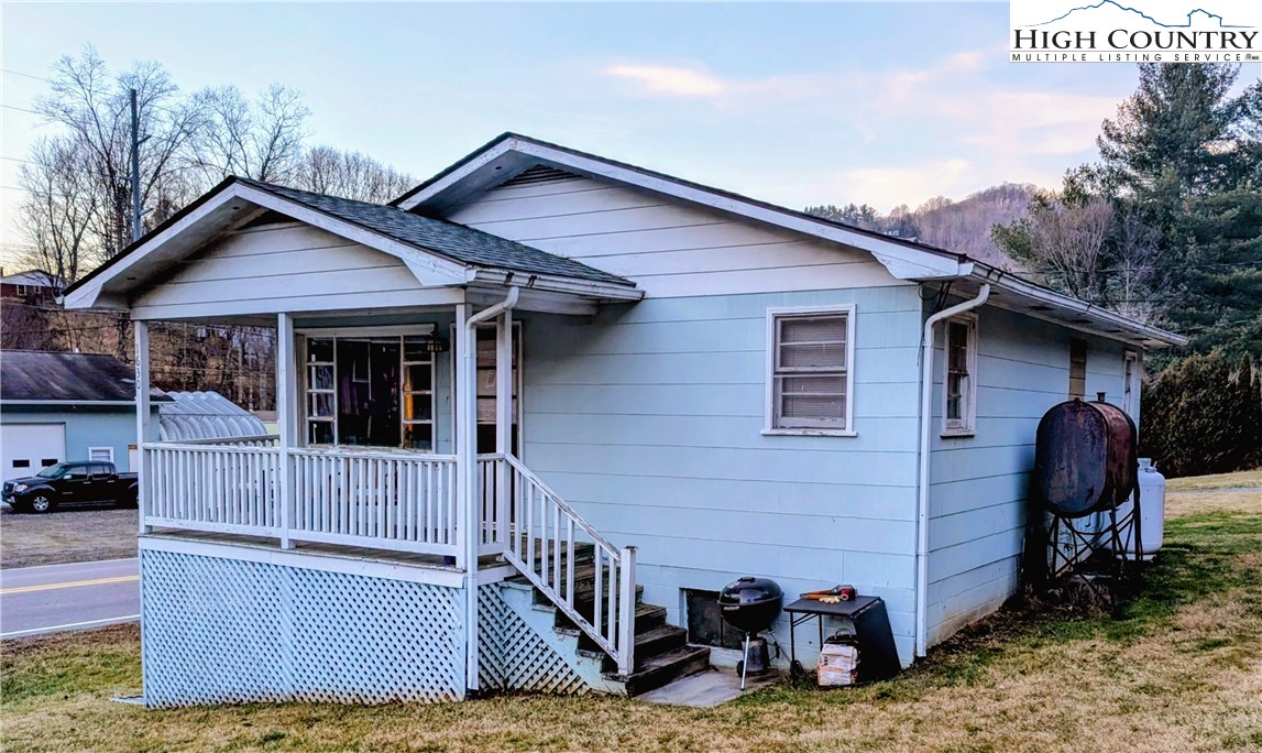 a view of a house with a yard and furniture